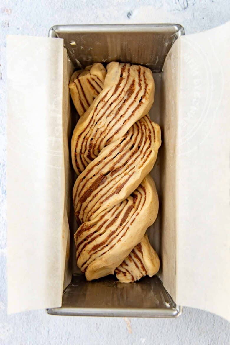 Twisted cinnamon babka placed in the loaf pan