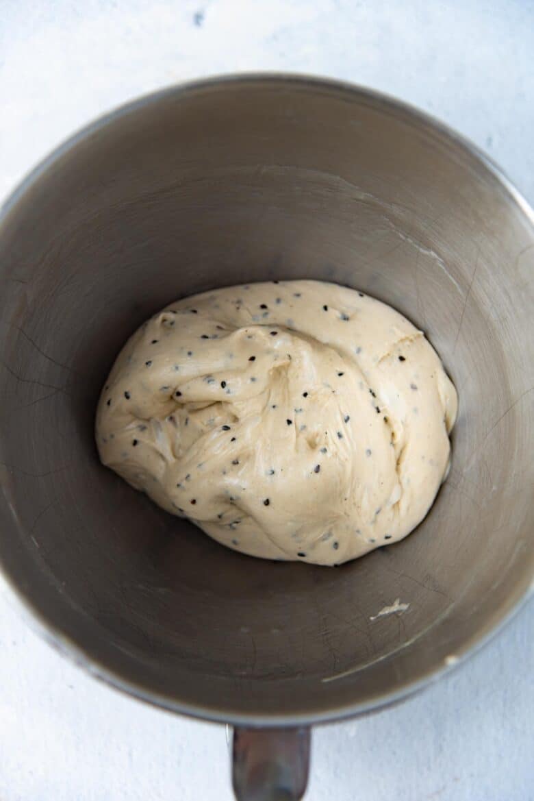 Smooth sesame bread dough in a mixer bowl with no sticky residue in the bowl