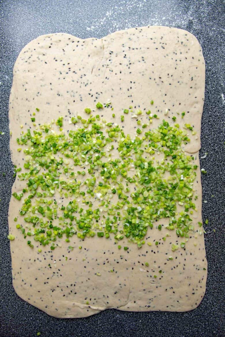 Finely chopped spring onions spread in the middle of the rolled out dough