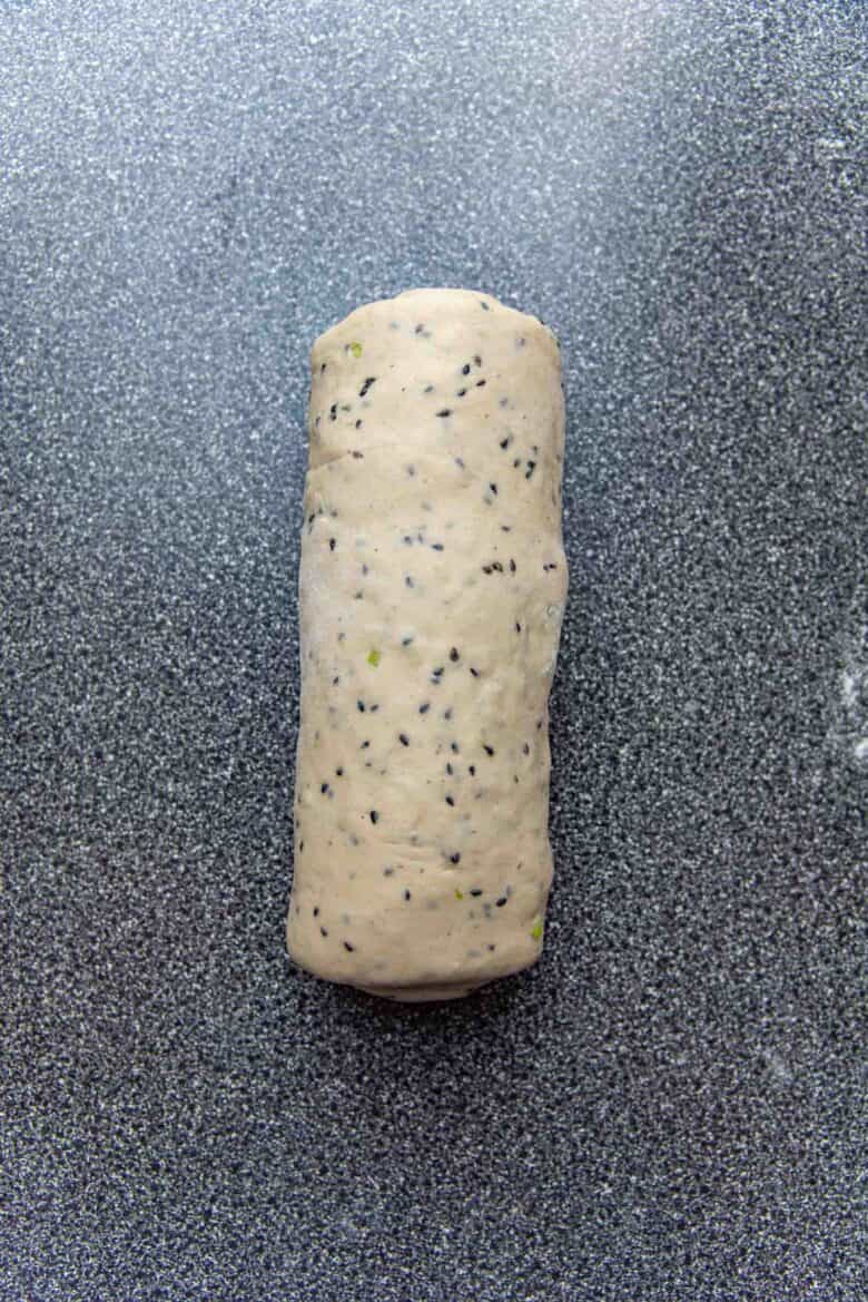 Overhead view of the rolled up sesame bread dough