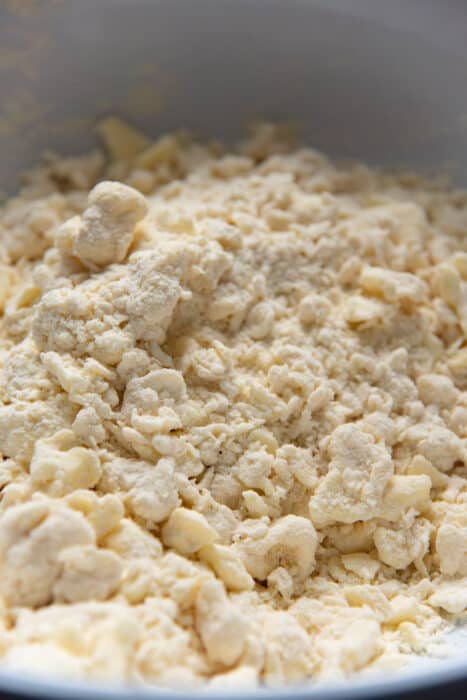 The pie dough forming larger clumps when liquid is added.