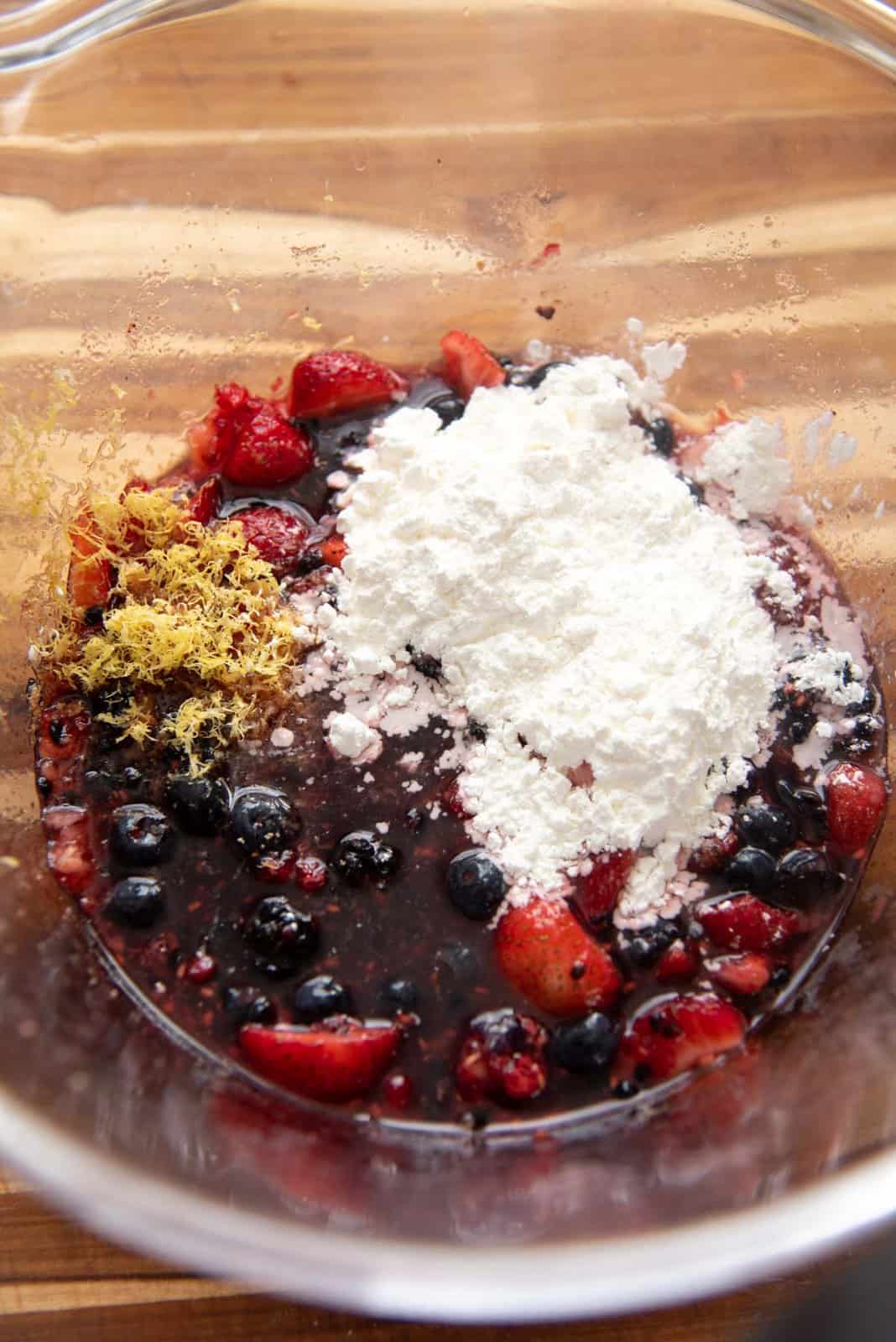 The crushed berries with lemon zest, juice and cornstarch placed on top before mixing.