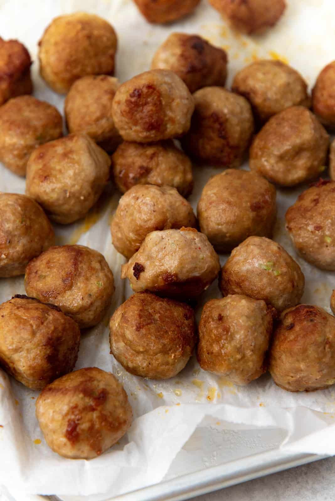 The meatballs that have been cooked in the pan.