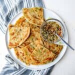 Scallion pancakes on a plate, overhead view. For featured image.