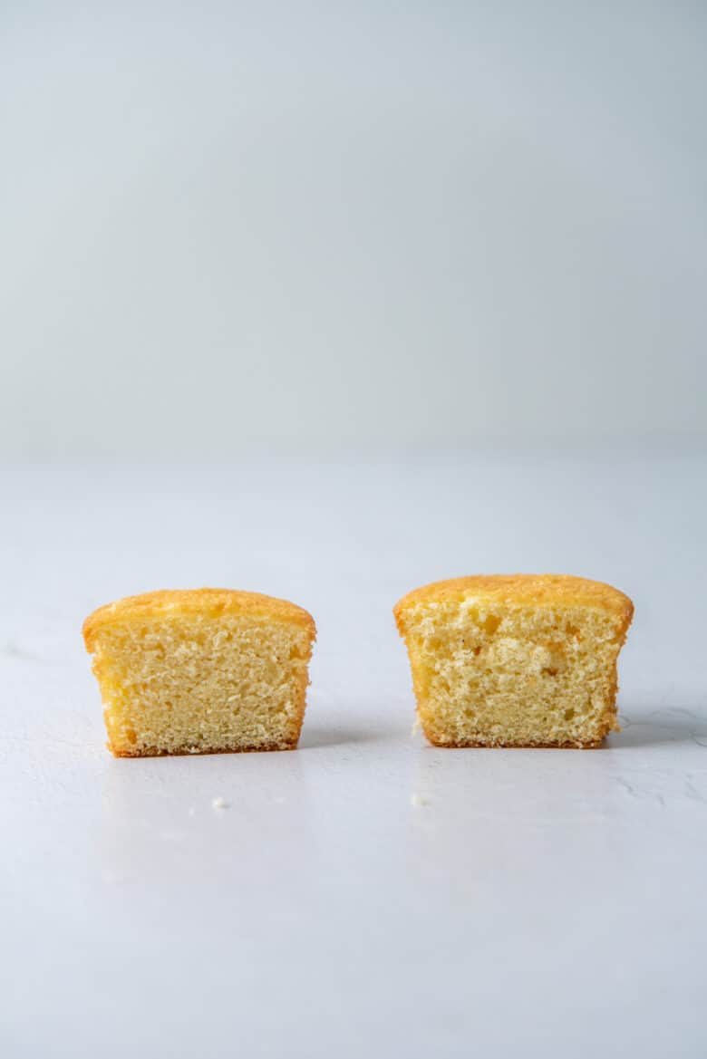 Two cupcakes cut in half to show the crumb in the cake.