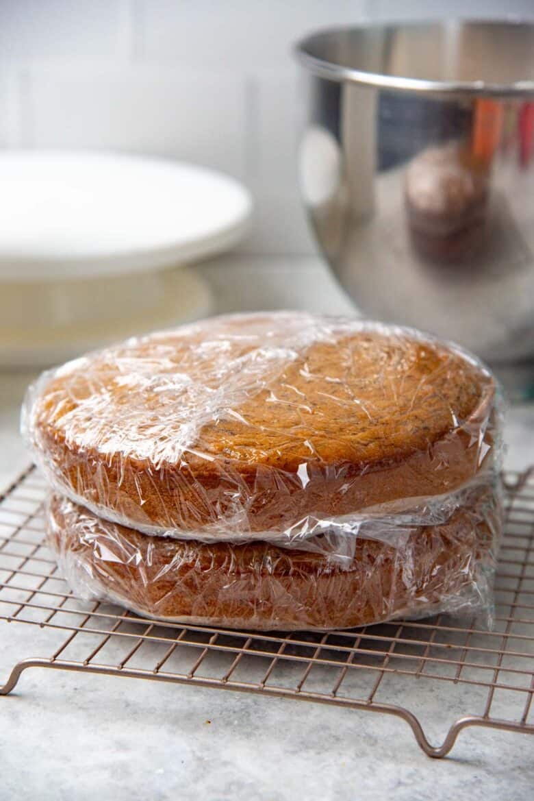 The banana cake layers wrapped individually with plastic wrap.