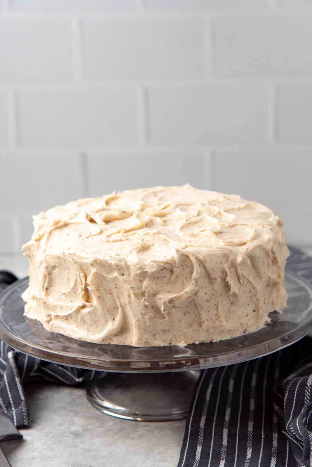 An old fashioned banana layer cake frosted with swirls of brown butter cream cheese frosting.