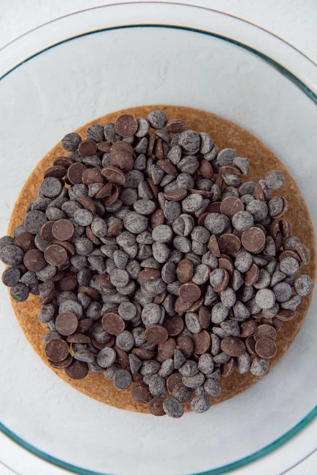 A bowl of dark chocolate in a large glass bowl.