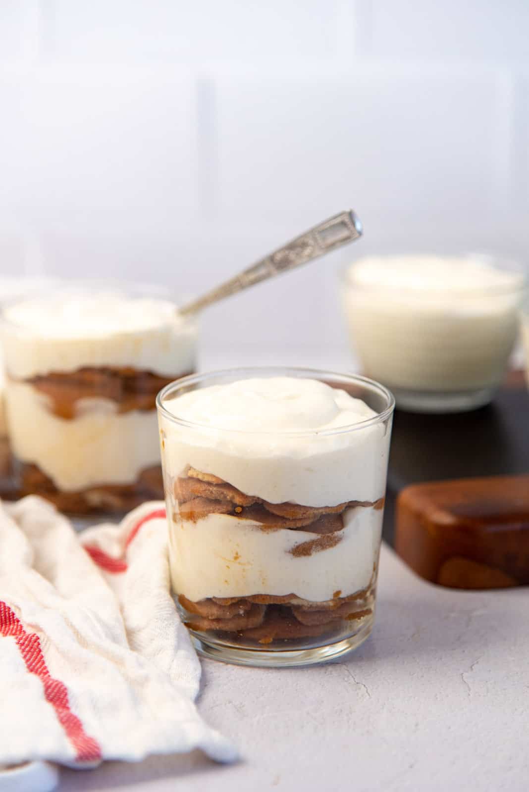 A close up of the trifle to show the airy texture of creme chiboust, layered between coffee soaked biscuits.