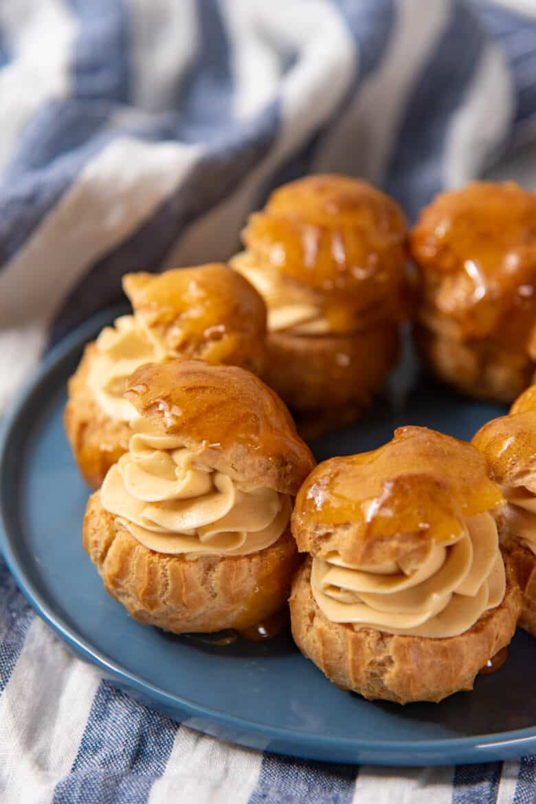 Mousseline cream piped inside choux buns with a caramel topping.