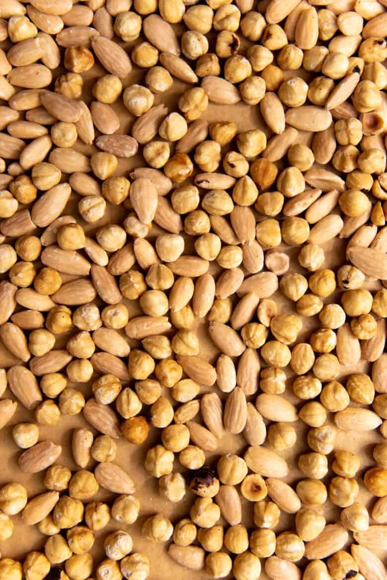 Overhead view of the hazelnuts and almonds after roasting in the oven.