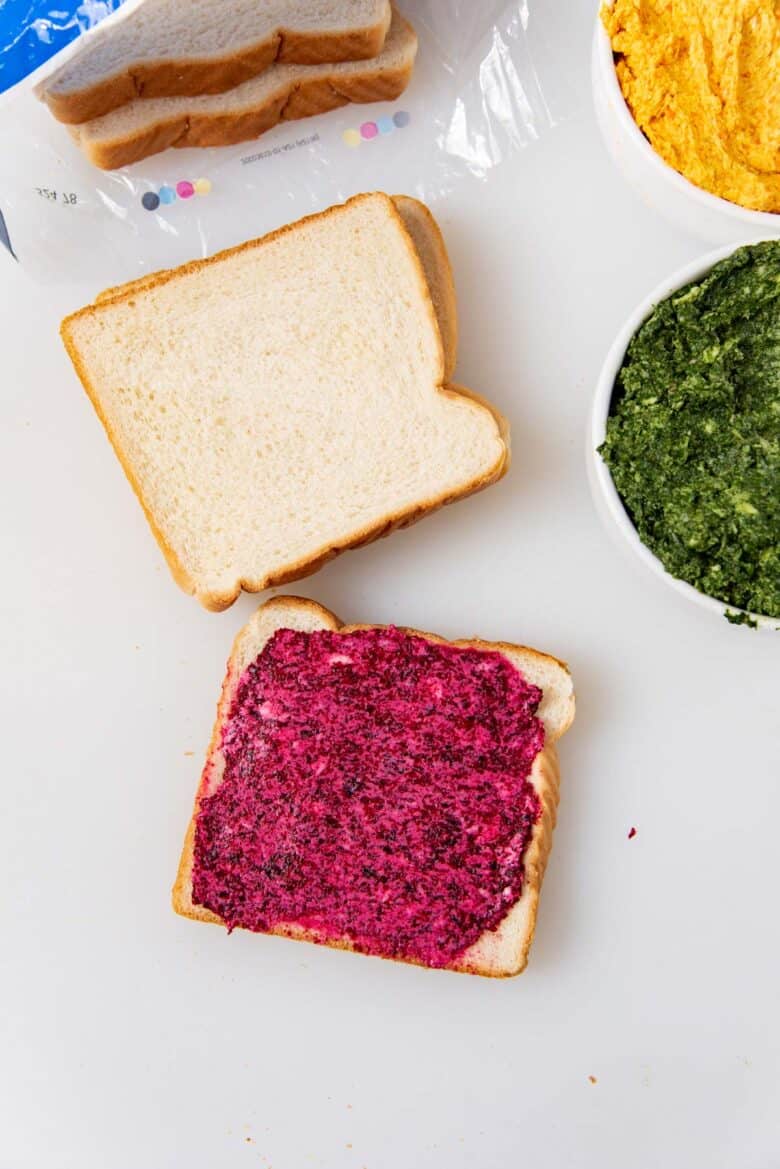 The beetroot butter filling spread on a slice of bread.