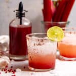 An ombre rhubarb margarita in a glass, square image.
