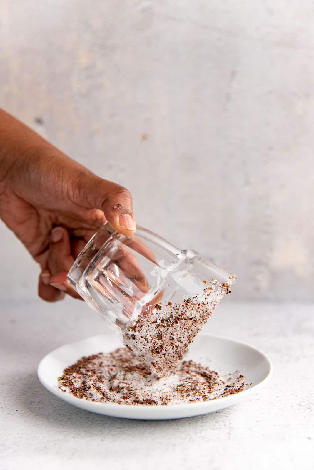 The glass held at an angle, to show the salted rim and side of the glass.