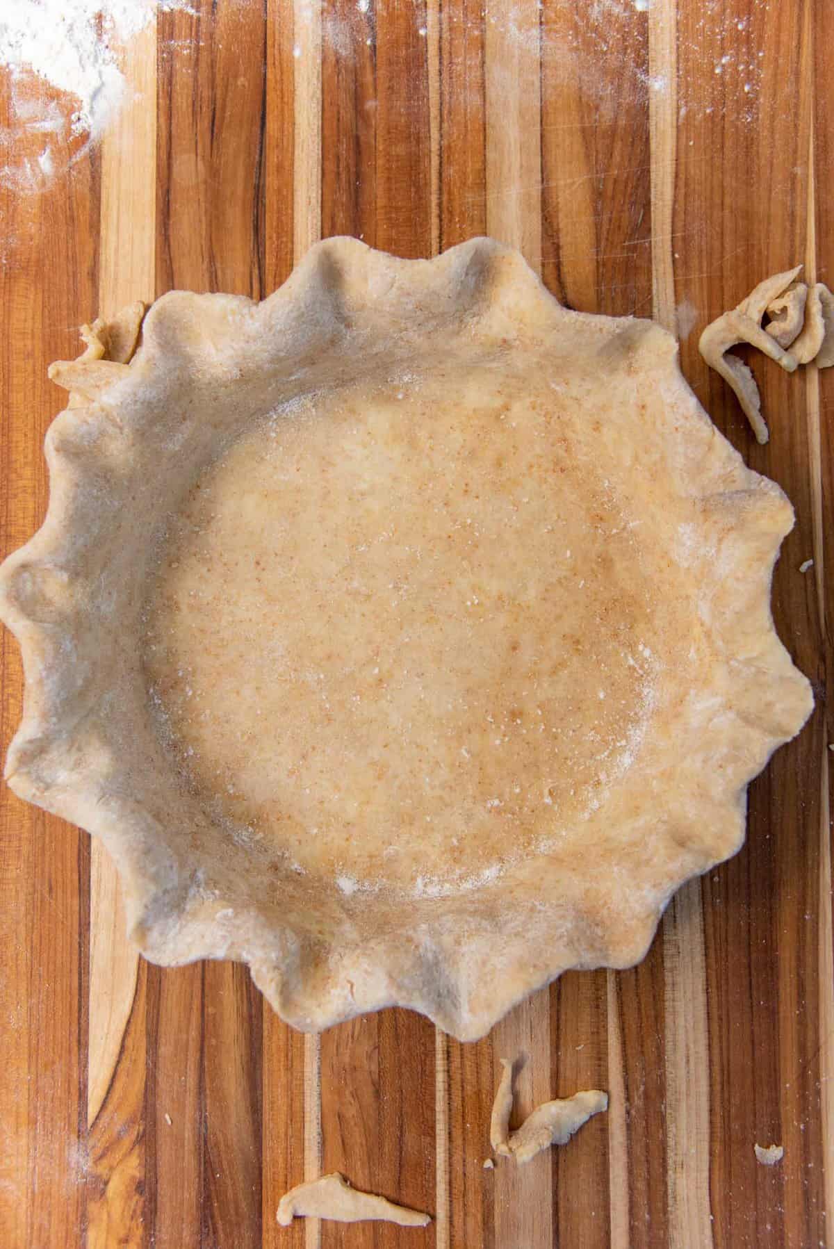Overhead view of the pie crust with fluted edges.