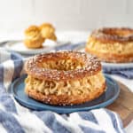 Large Paris-brest pastry filled with mousseline cream and topped with pearl sugar.