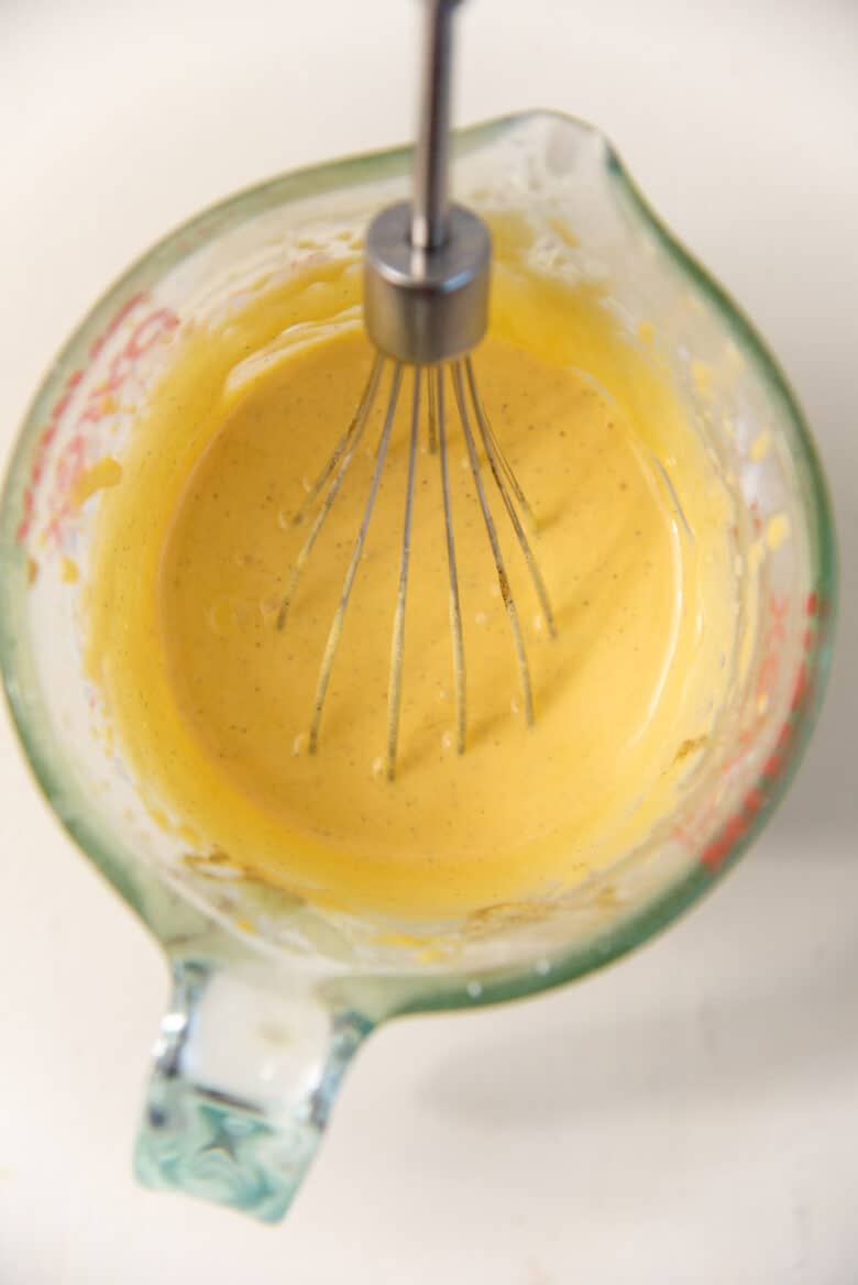 Egg yolks mixture whisked in a jug until pale and fluffy.