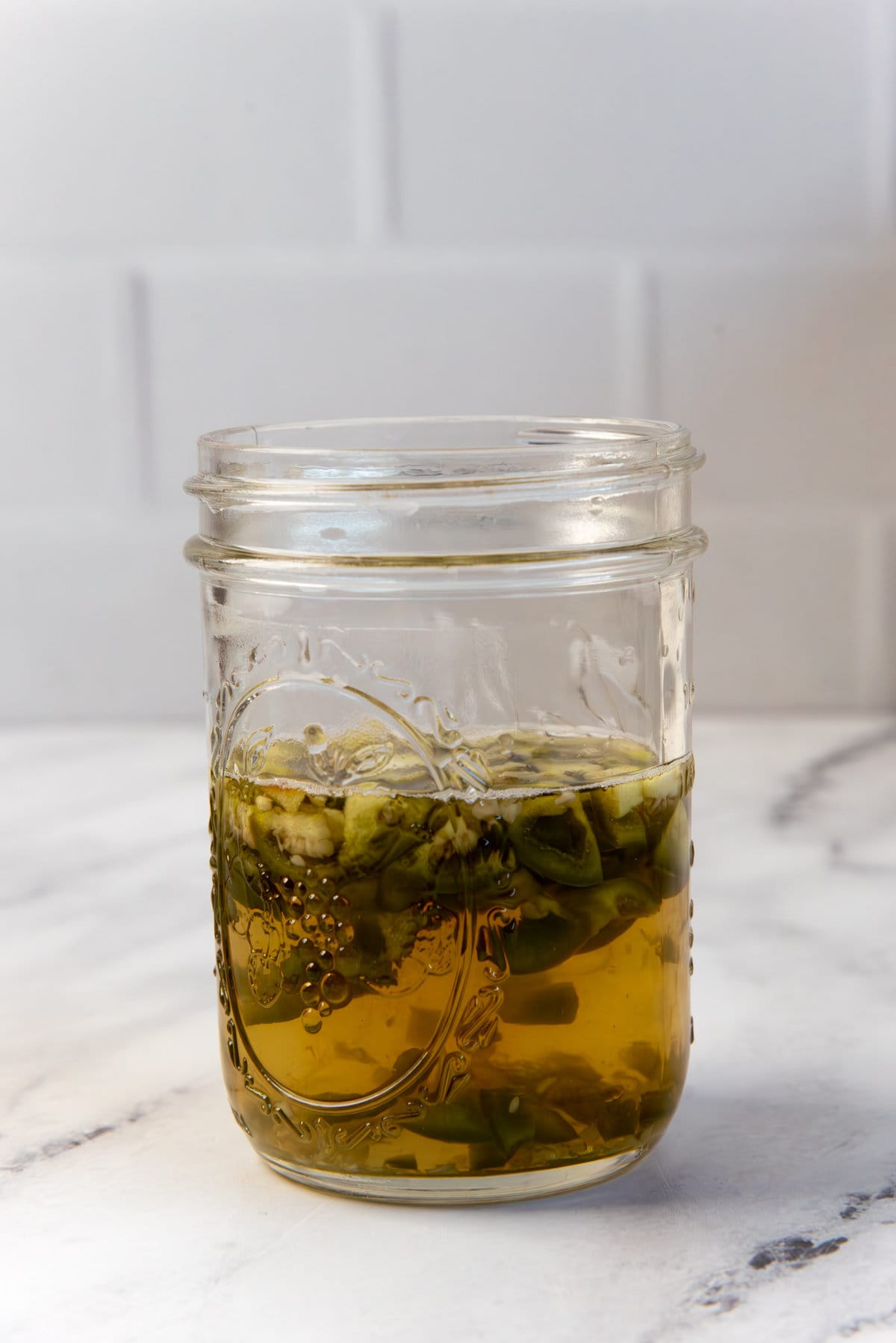 Jalapeno and gold tequila infused in a ball mason jar.