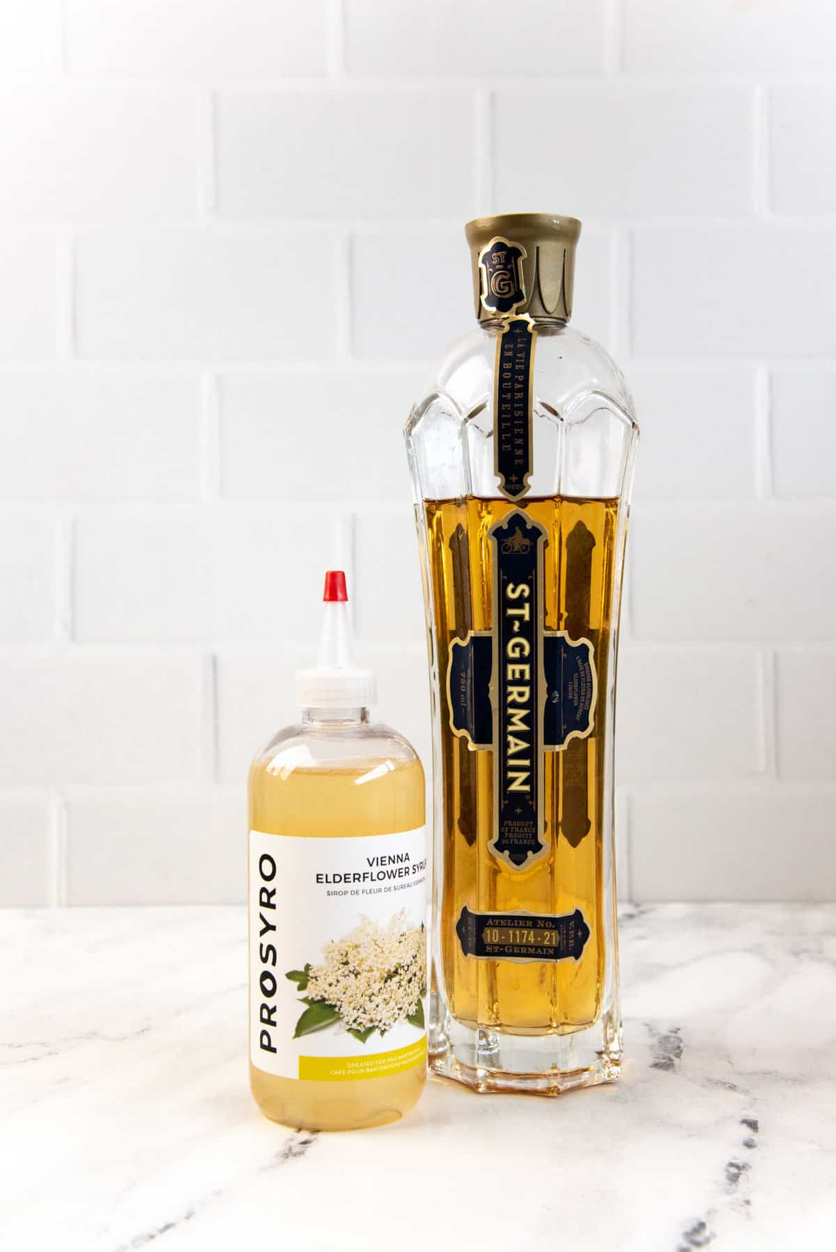 St Germain liqueur and an elderflower syrup bottle next to each other.
