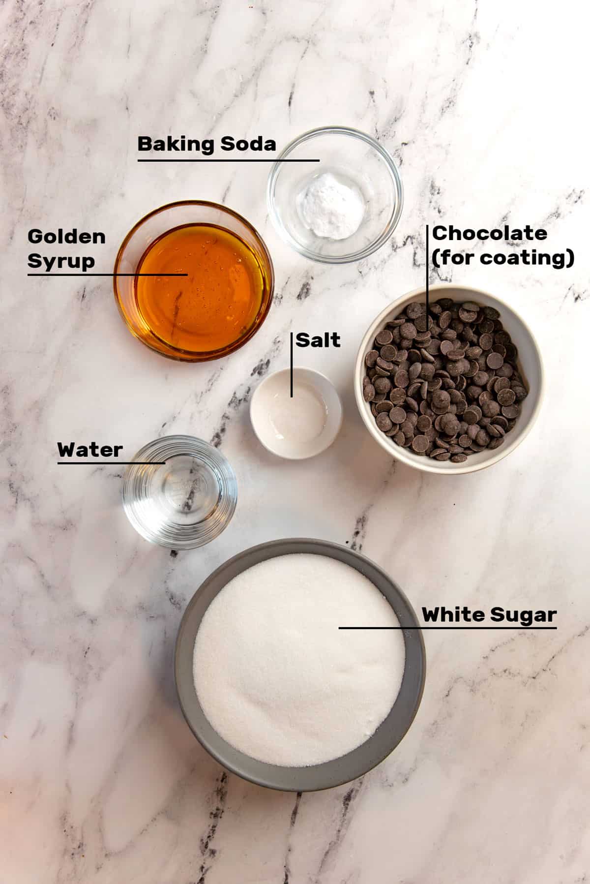 Overhead view of ingredients needed in individual bowls to make honeycomb candy