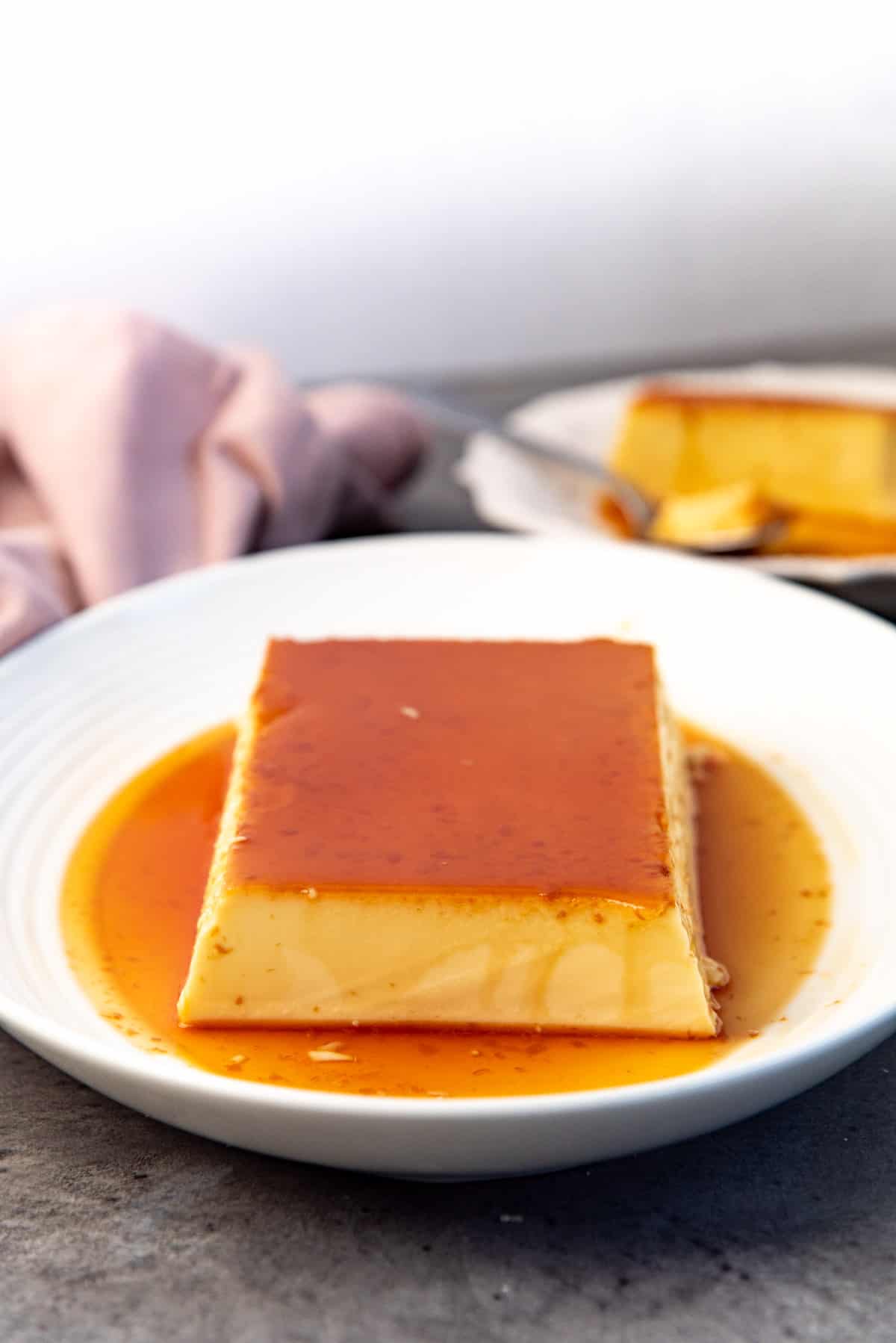 An image of a large portion cream caramel baked in a loaf pan, serve on a serving platter.