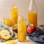 Square image of apple lemonde served in a glass.