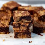 Stack of brookies showing moist, fudgy texture and chocolate chunks in the middle.